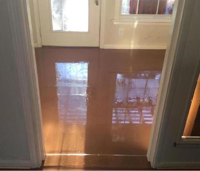Wet floor, water standing on floor. Water damage in a home