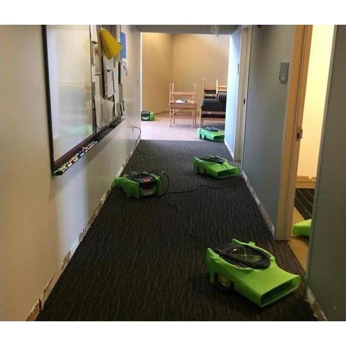Five air movers placed on the hallway of a commercial building. Concept drying a commercial facility