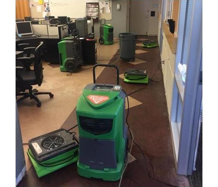 Air movers and dehumidifiers placed in office due to water damage